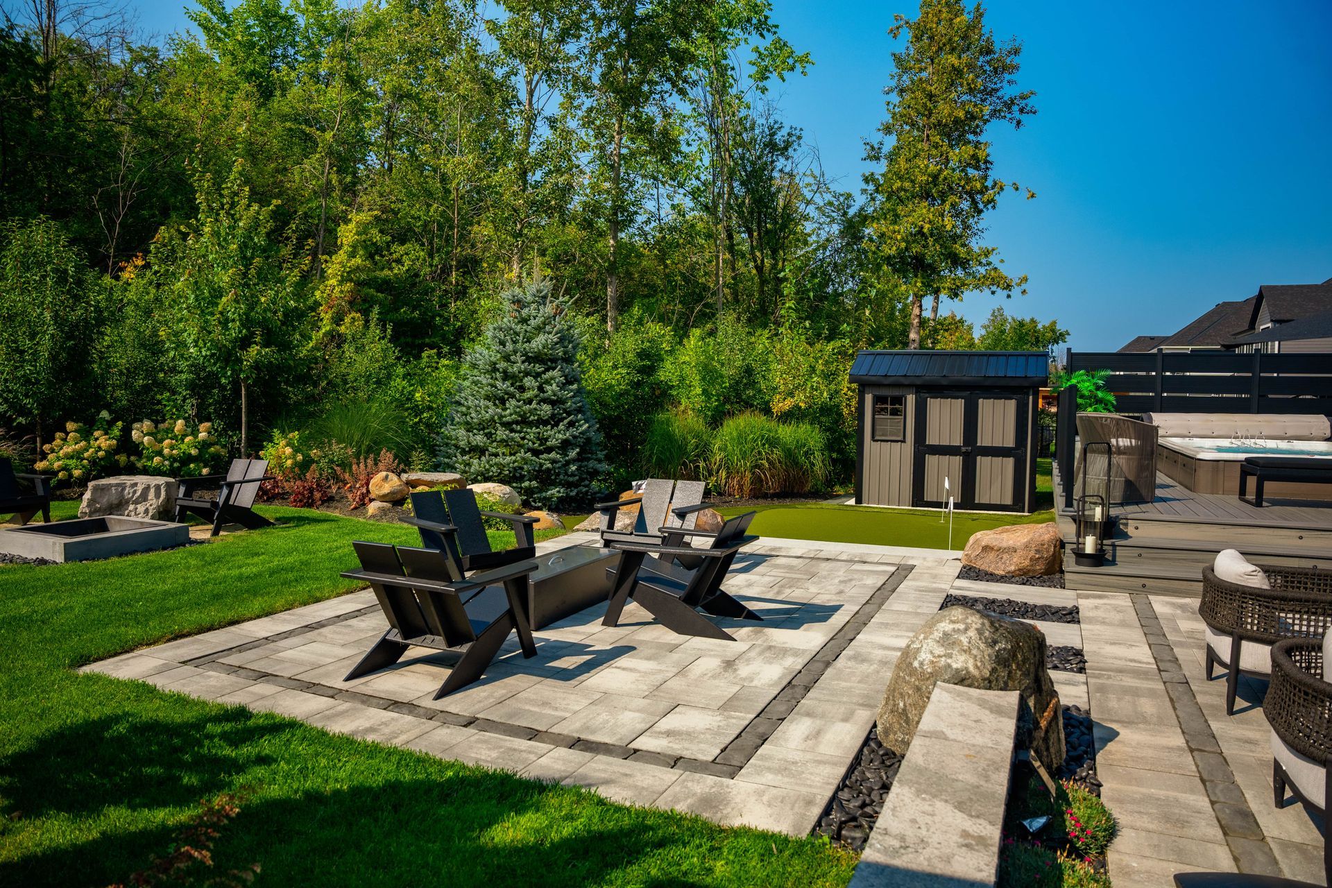 Modern backyard patio with fire pit and hot tub