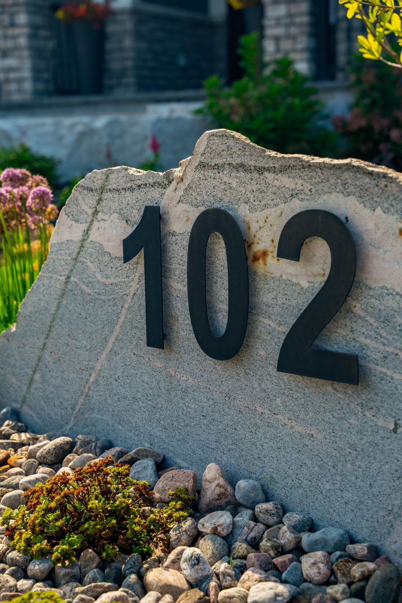 Stone address marker with number 102