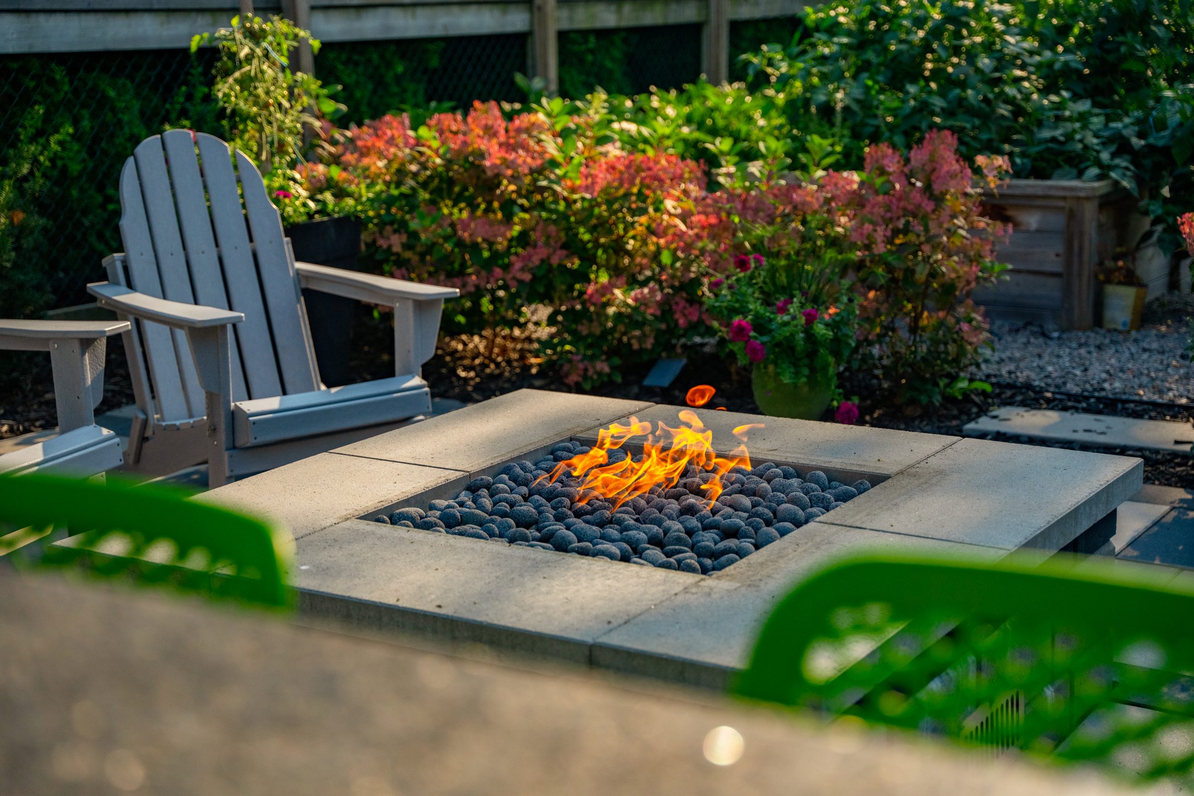 Modern backyard fire pit with Adirondack chairs