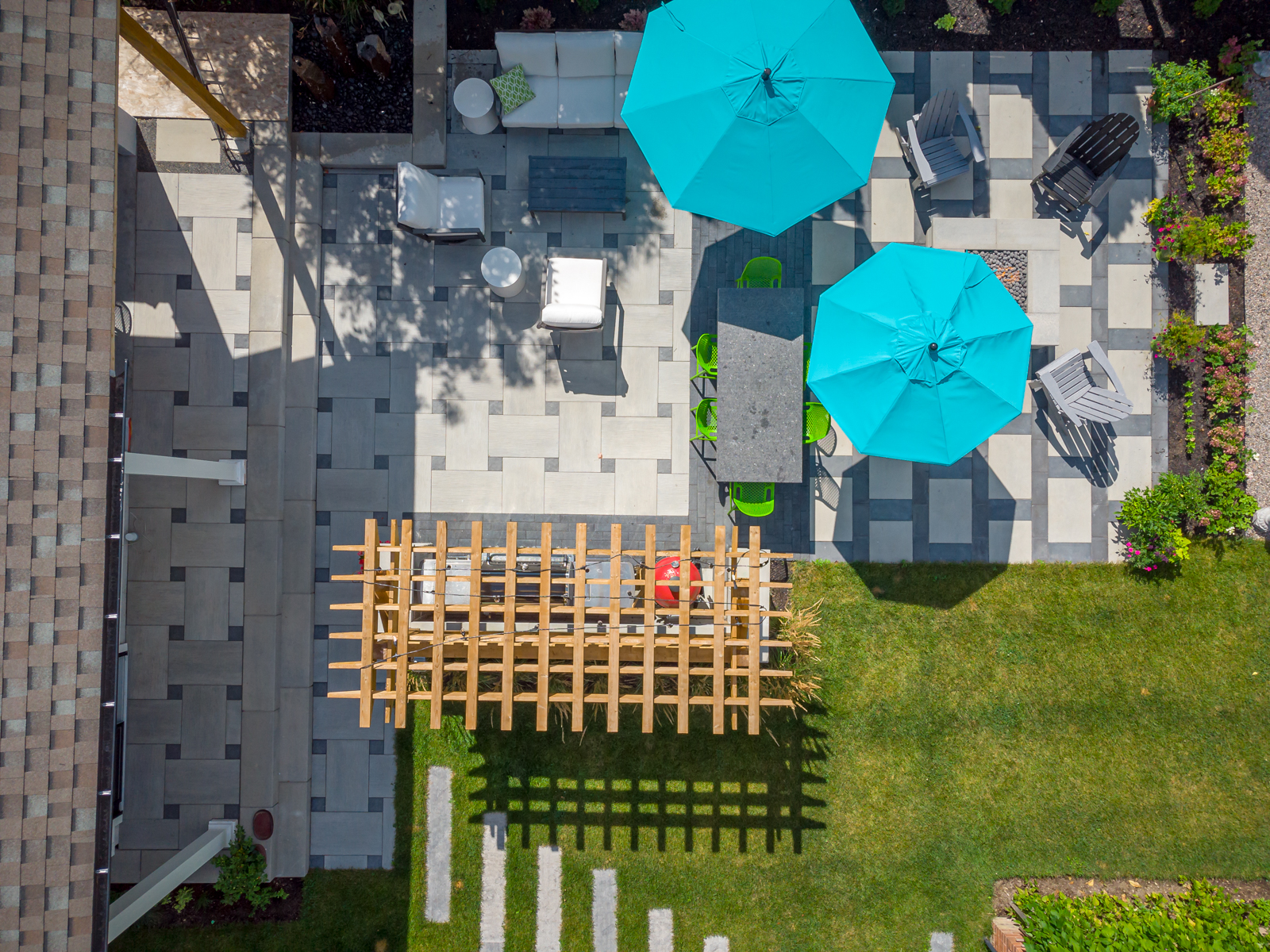 Overhead view of modern backyard patio and lawn