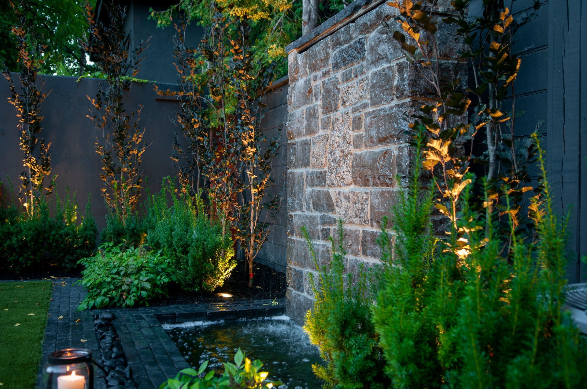 Modern garden with stone wall water feature