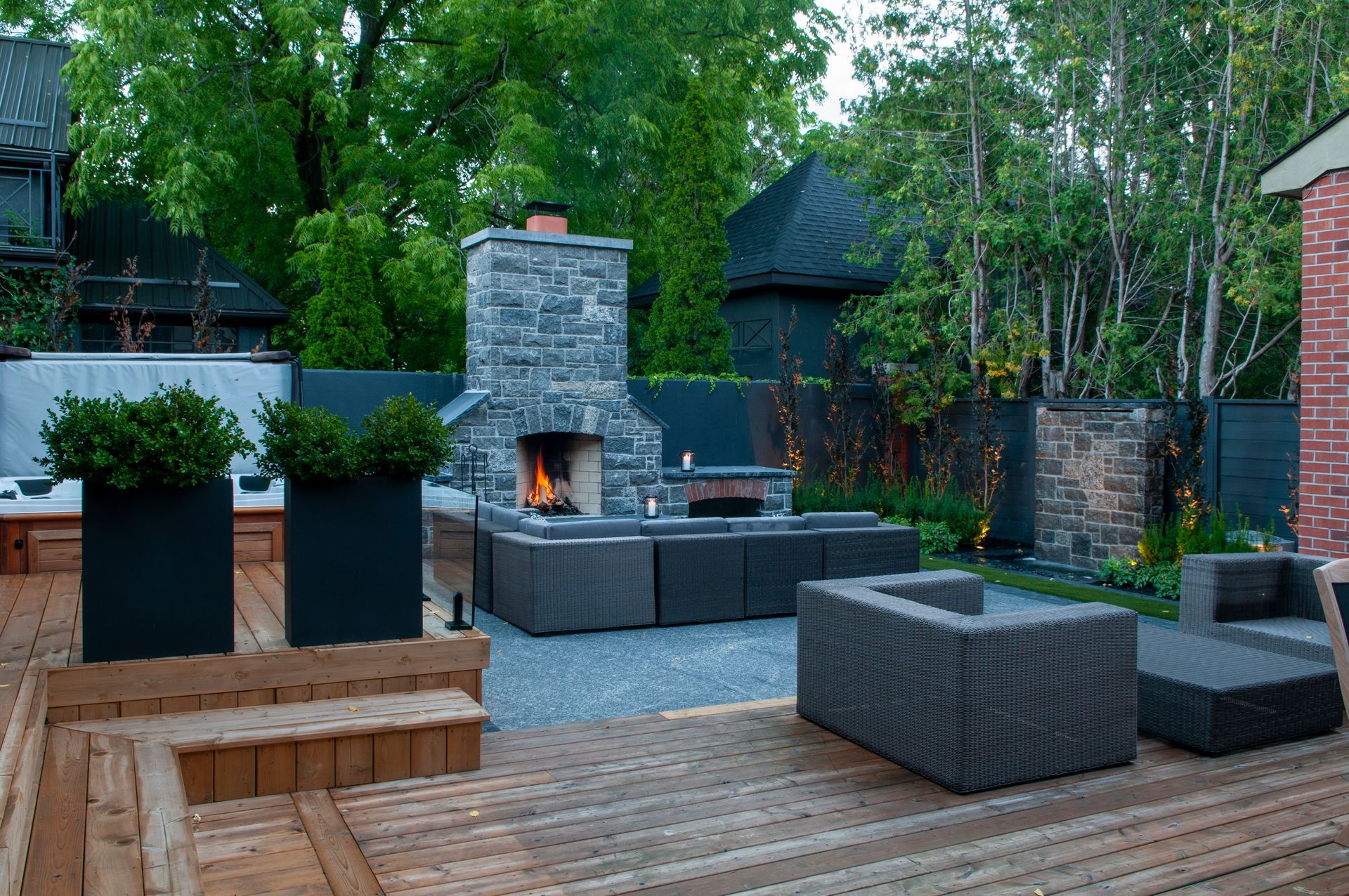 Modern backyard patio with stone fireplace and seating