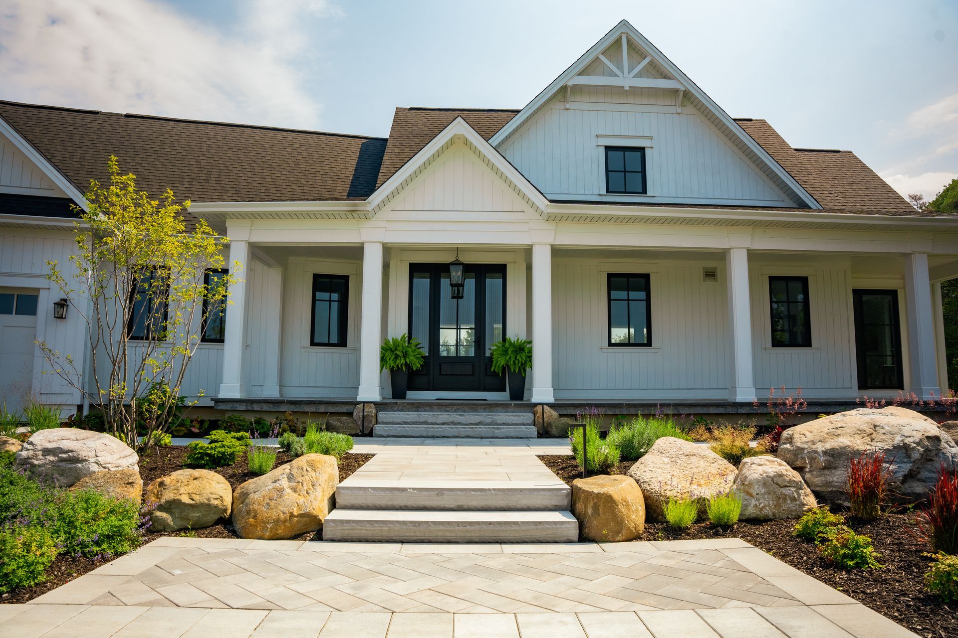 Modern white farmhouse with landscaped front yard